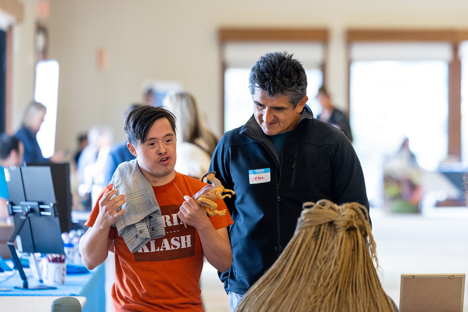 Father and son talking while at an Self-Determination Program resource fair.