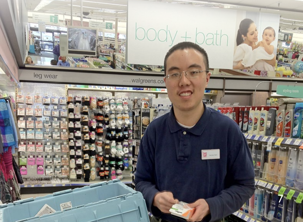 Portrait of a person with I/DD working at Walgreens stocking shelves, showing GGRC's employment services.